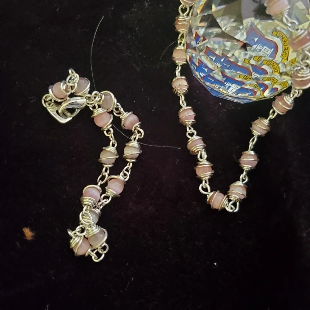 Two silver with pink pearl stones